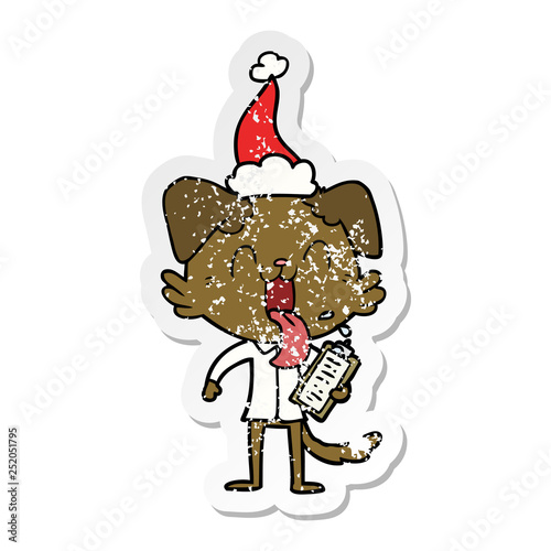 distressed sticker cartoon of a panting dog with clipboard wearing santa hat