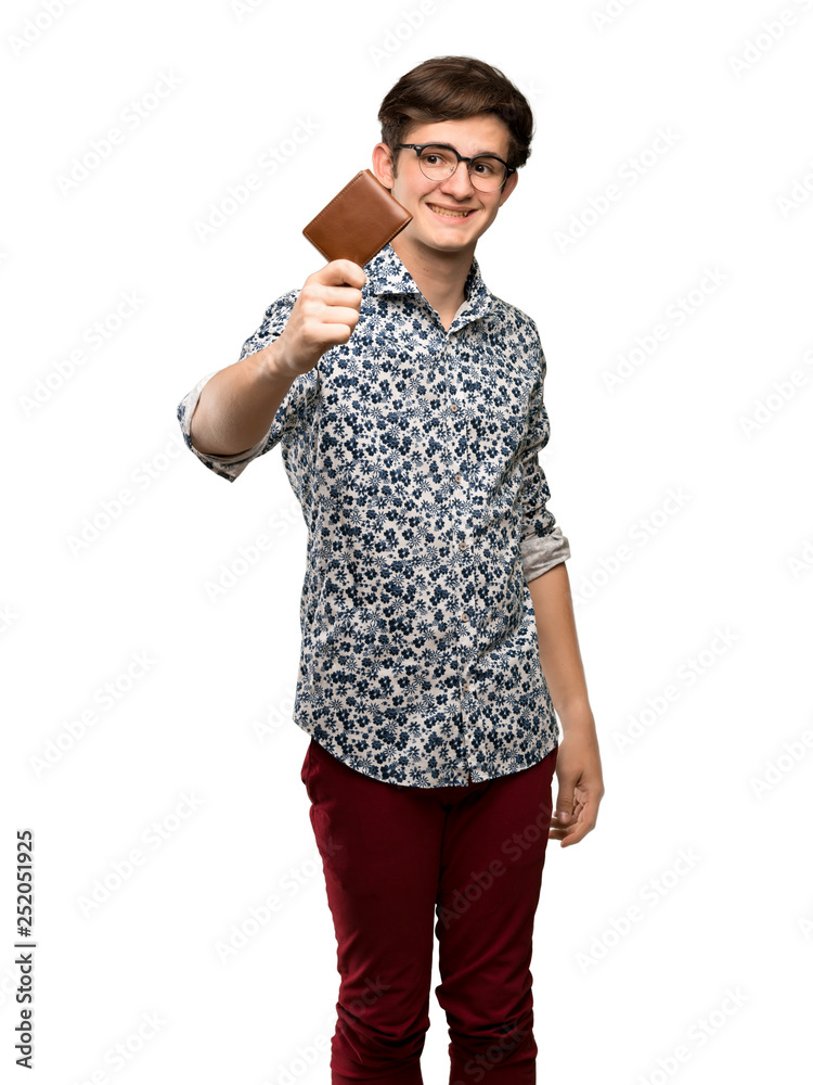 Teenager man with flower shirt and glasses holding a wallet over isolated white background Teenager man with flower shirt and glasses holding a wallet over isolated white background