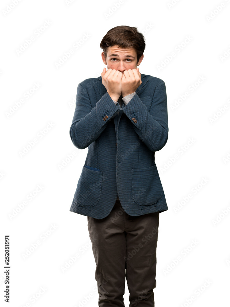 Teenager man with turtleneck nervous and scared putting hands to mouth over isolated white background Teenager man with turtleneck nervous and scared putting hands to mouth over isolated white background