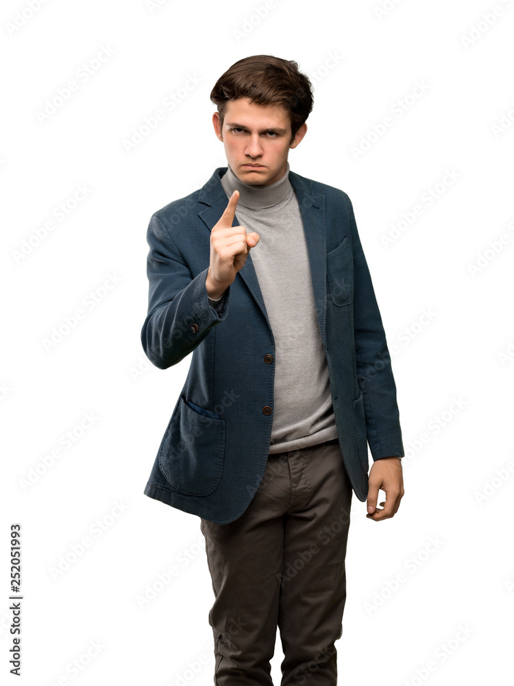 Teenager man with turtleneck frustrated and pointing to the front over isolated white background Teenager man with turtleneck frustrated and pointing to the front over isolated white background