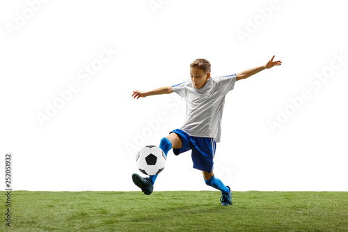 Young boy with soccer ball running and jumping isolated on white studio background. Junior football soccer player in motion © master1305