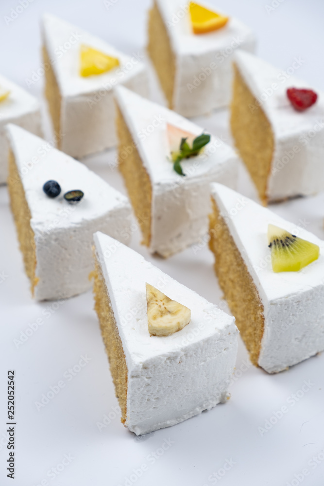 Delicious creamy minimal white cake with fruit on white background. Delicious creamy minimal white cake with fruit on white background.