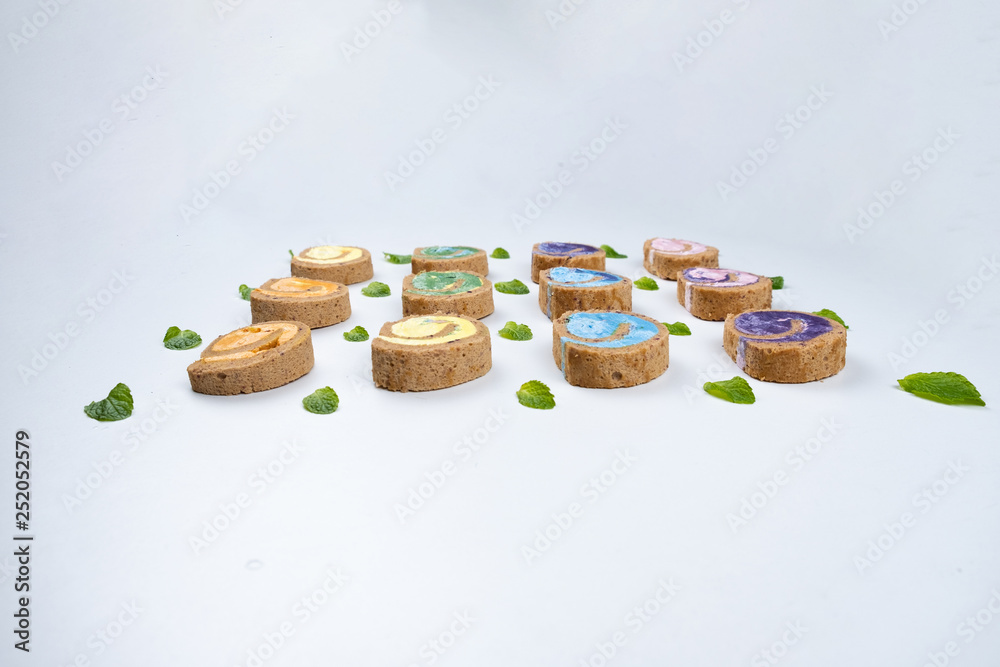 Delicious creamy colourful minimal cake roll on white background. Delicious creamy colourful minimal cake roll on white background.