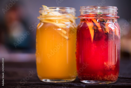 Two glass jars with delicious hot winter beverages close