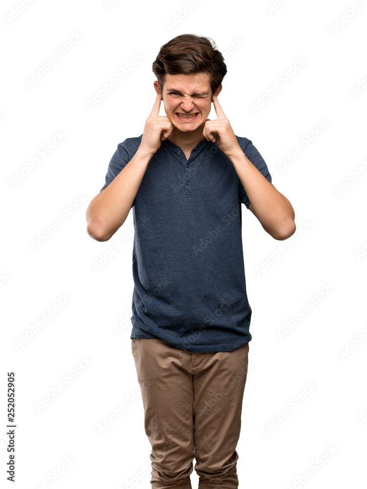 Teenager man frustrated and covering ears with hands over isolated white background Teenager man frustrated and covering ears with hands over isolated white background