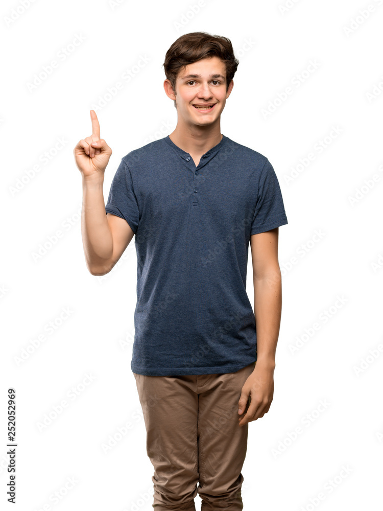Teenager man showing and lifting a finger in sign of the best over isolated white background Teenager man showing and lifting a finger in sign of the best over isolated white background