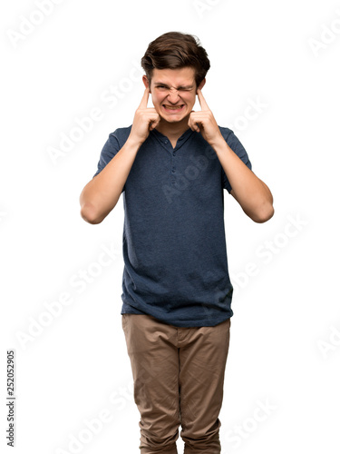 Teenager man frustrated and covering ears with hands over isolated white background