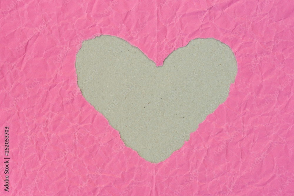 heart shape hole on piece on pink paper heart shape hole on piece on pink paper