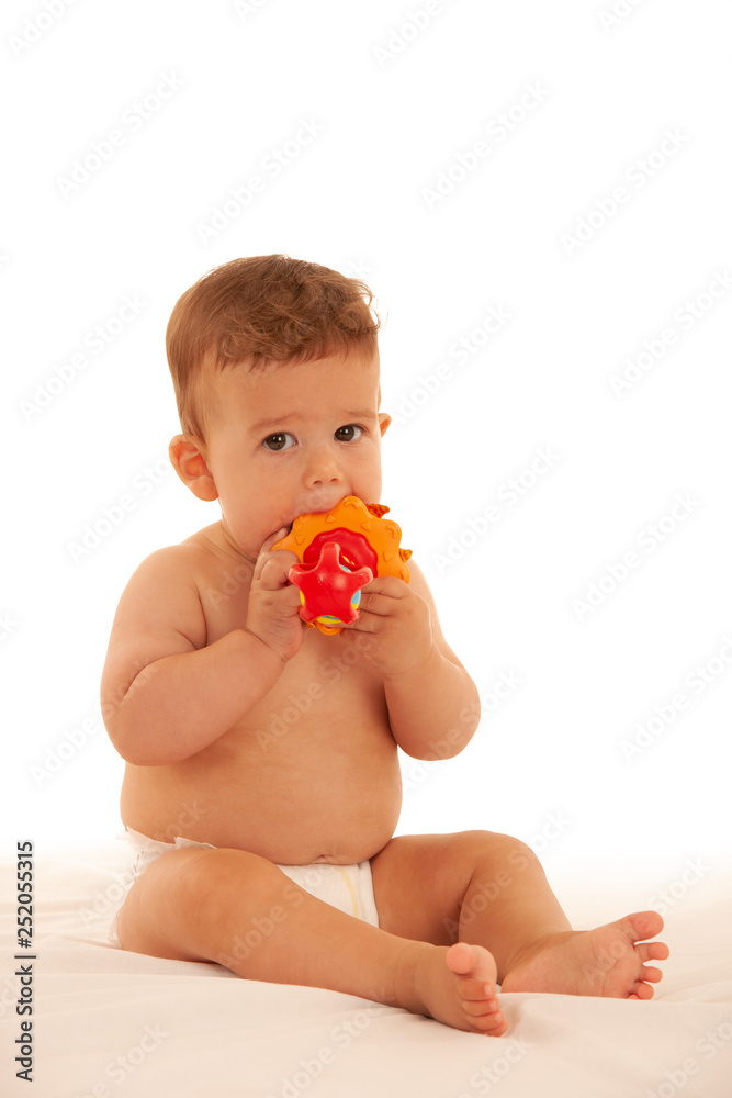 Hapy baby boy in playing on bed isolated over white Hapy baby boy in playing on bed isolated over white