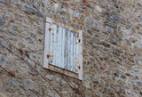Closed wooden window in the  day. Wall in the old city, Budva, Montenegro