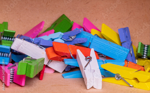 lots of colorful clothespins in a small wooden box