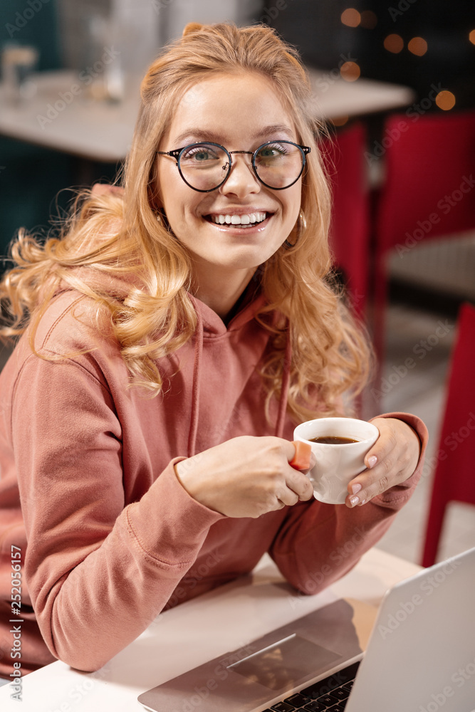Female customer looking at the camera and smiling to waiter. Female customer looking at the camera and smiling to waiter.