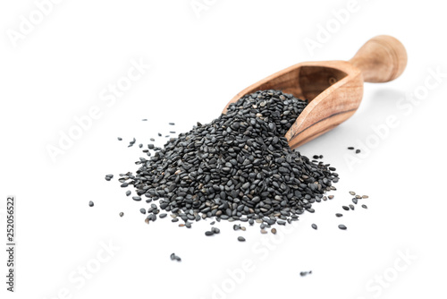 Black organic sesame seeds in wooden scoop