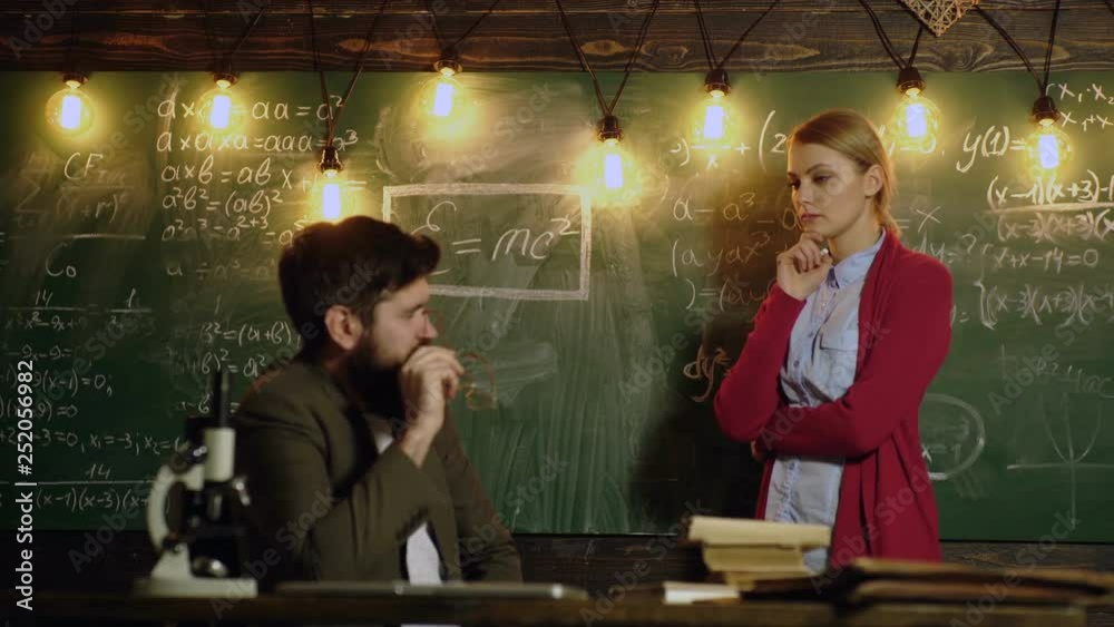 Student girl talking with professor. Female student with a teacher in classroom. Classmate Educate Friend Knowledge Lesson Concept. Learning concept. Teacher and student. Back to school.