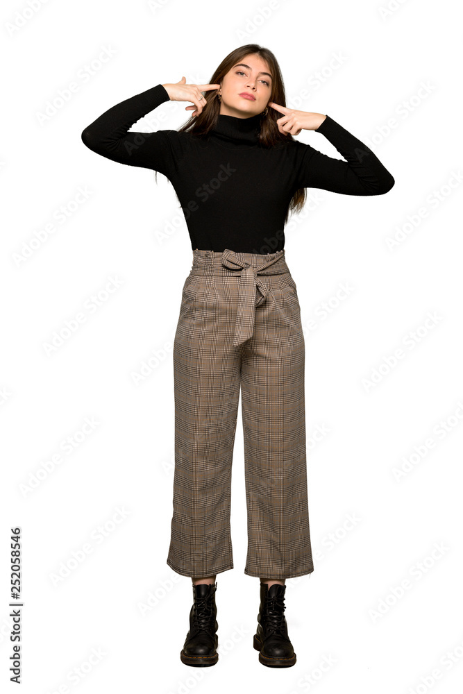 Full-length shot of Pretty girl covering both ears with hands on isolated white background Full-length shot of Pretty girl covering both ears with hands on isolated white background