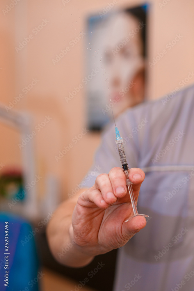 Cosmetology. Doctor with a syringe in his hands. Doctor. Syringe. Cosmetic procedure. Cosmetology. Doctor with a syringe in his hands. Doctor. Syringe. Cosmetic procedure.