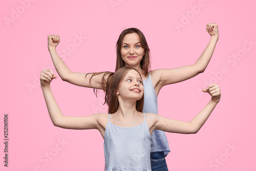 Mother and daughter showing biceps 