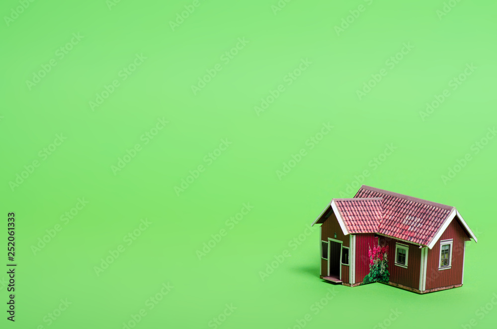 Small house model home on green background Small house model home on green background