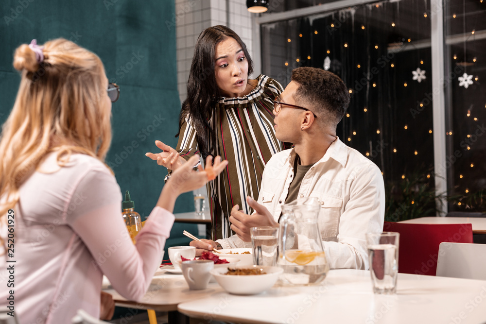 Young woman offended by her boyfriend because he having dinner with her friend. Young woman offended by her boyfriend because he having dinner with her friend.