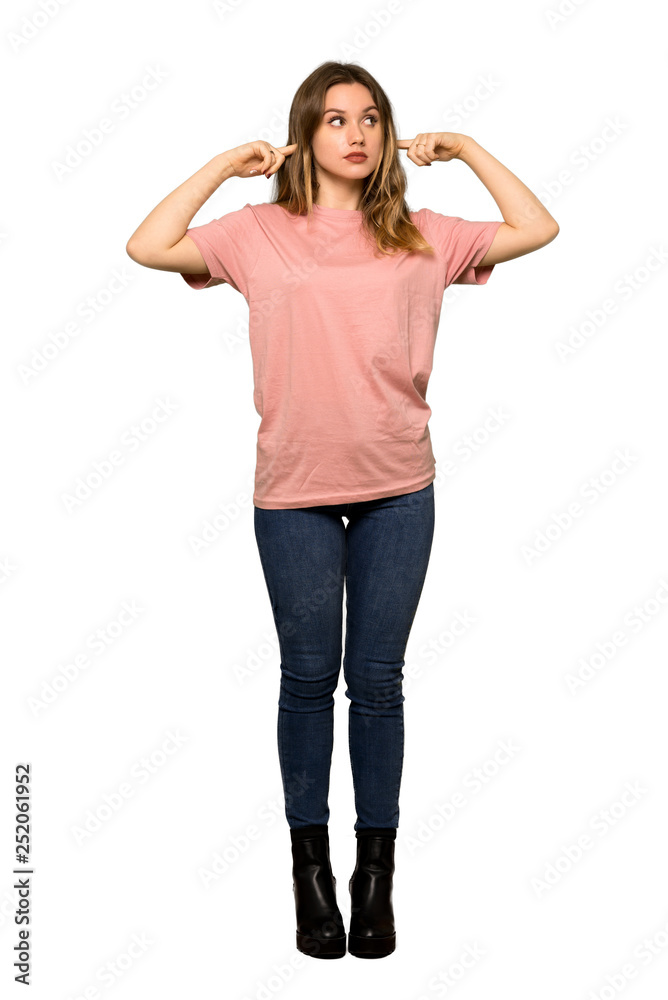 A full-length shot of a Teenager girl with pink sweater covering mouth with hands for saying something inappropriate on isolated white background A full-length shot of a Teenager girl with pink sweater covering mouth with hands for saying something inappropriate on isolated white background