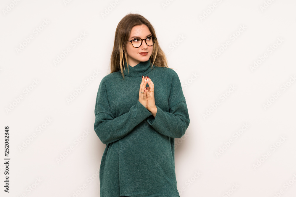 Teenager girl over white wall scheming something Teenager girl over white wall scheming something
