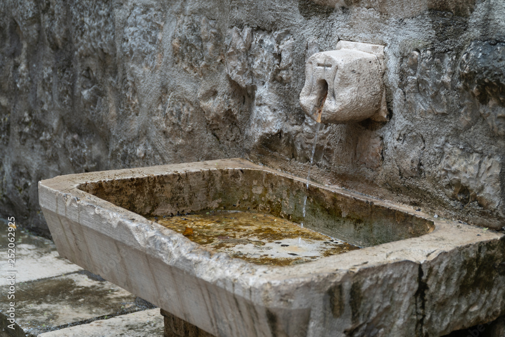 Stone sink near the temple in the old European city. Stone sink near the temple in the old European city.