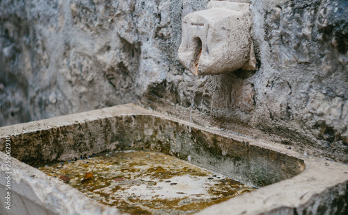 Stone sink near the temple in the old European city.