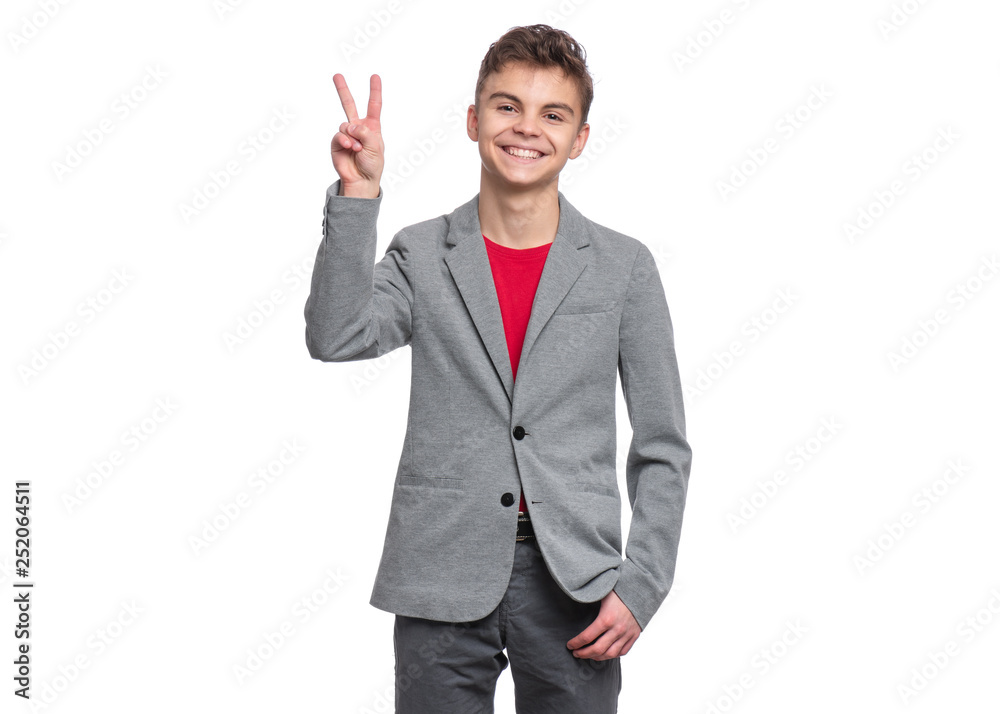 Handsome Teen Boy in suit making Victory Gesture. Portrait of caucasian Smiling Teenager isolated on white background. Happy child looking at camera. Handsome Teen Boy in suit making Victory Gesture. Portrait of caucasian Smiling Teenager isolated on white background. Happy child looking at camera.