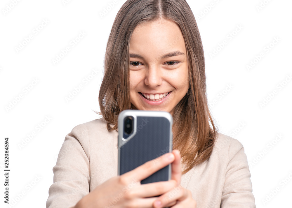 Portrait of beautiful Teen Girl talk to Mobile Phone, isolated on white background. Smiling Child standing and using Cell Phone. Pretty modern Teenager taking Selfie photo on Smartphone. Portrait of beautiful Teen Girl talk to Mobile Phone, isolated on white background. Smiling Child standing and using Cell Phone. Pretty modern Teenager taking Selfie photo on Smartphone.