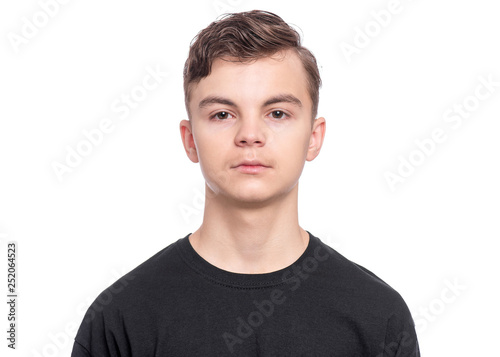 Handsome Teen Boy in black T-Shirt. Portrait of caucasian Smiling Teenager isolated on white background. Happy child looking at camera.