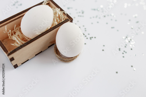 Easter. Easter eggs in a wooden box. Silver. Bokeh.