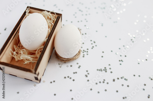 Easter. Easter eggs in a wooden box. Silver. Bokeh.