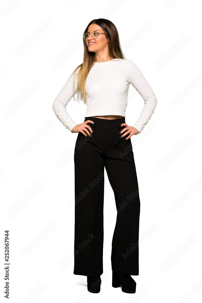 Full body of Pretty woman with glasses posing with arms at hip and laughing Full body of Pretty woman with glasses posing with arms at hip and laughing