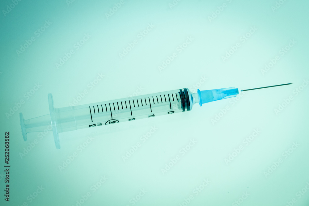 Syringe on blue background Syringe on blue background