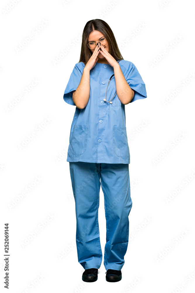 Full body of Young nurse smiling a lot while covering mouth Full body of Young nurse smiling a lot while covering mouth