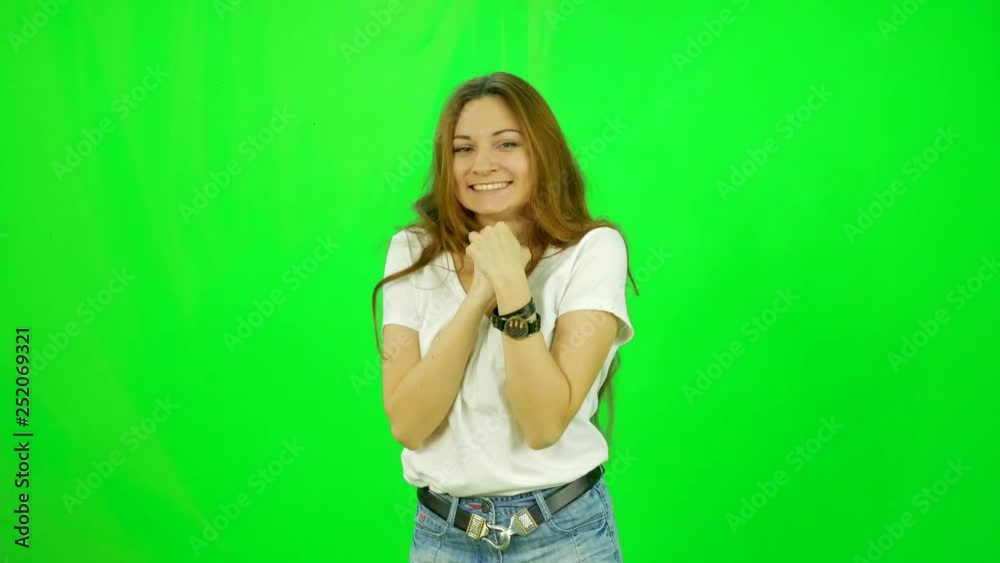 Young woman celebrates her victory and has a fun close-up green-screen shot Young woman celebrates her victory and has a fun close-up green-screen shot