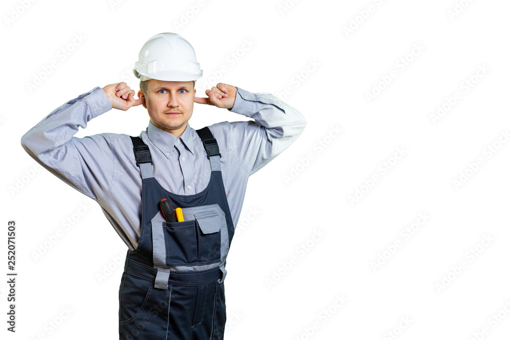 Portrait of young architect covering ears like not hearing and smiling on isolated background Portrait of young architect covering ears like not hearing and smiling on isolated background