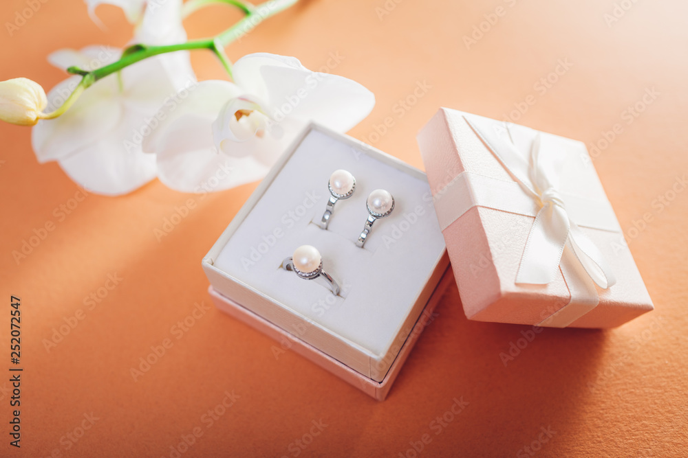 Gift box with a set of perl jewellery surrounded with orchid. Present for Women's day Gift box with a set of perl jewellery surrounded with orchid. Present for Women's day