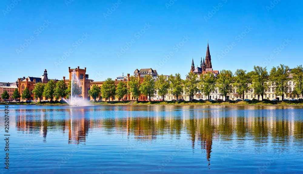 Lake Pfaffenteich in Schwerin with fountain in front of the Arsenal. Mecklenburg-Vorpommern, Germany