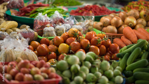 A stack of fresh vegetables for sale at market.