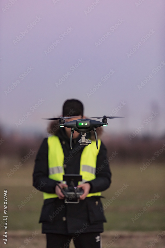 Fototapeta premium pilot of the drone at work, video shooting with UAV