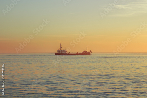 Boat on the ocean with sunset colors © Sergiodesilva