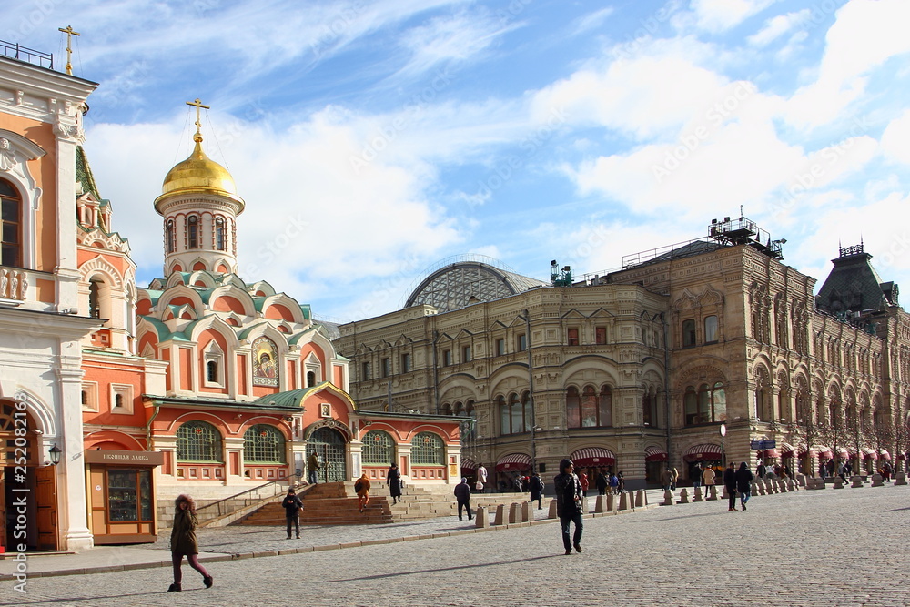 Moscow / Russia – View of Kazan Cathedral and GUM Department store on Red Square from resurrection gate in spring on cloudy blue sky background