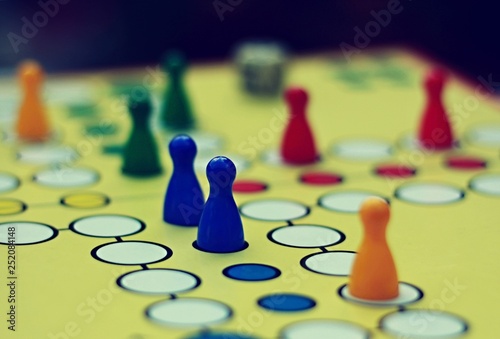 Ludo. Board game. Colorful figures on the board