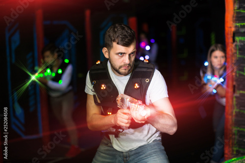 Guy in colored beams during laser tag game