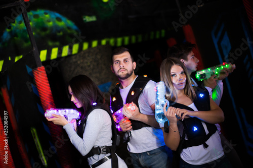Young people playing laser tag