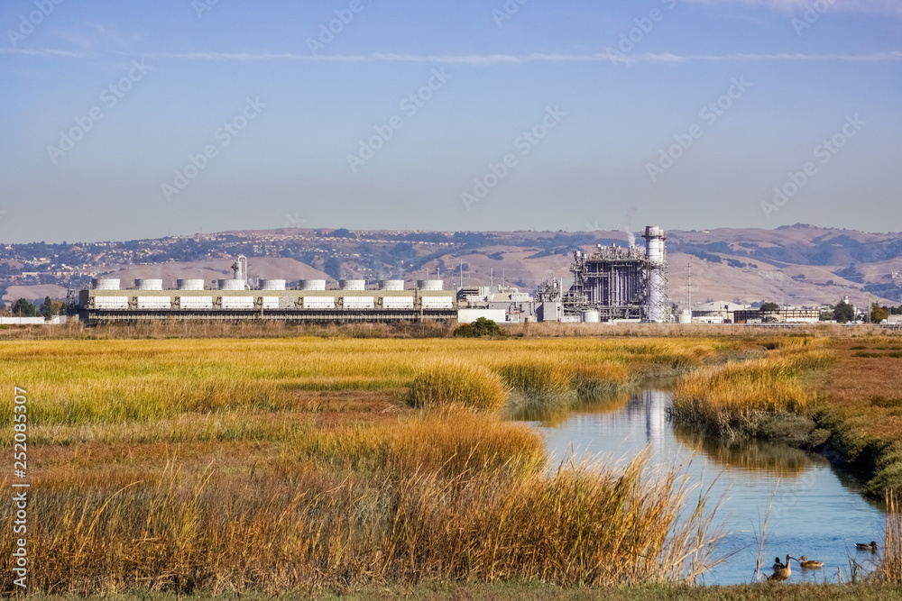 The marshes of East San Francisco bay; on the background the city power plant, Hayward, east San Francisco bay area, California