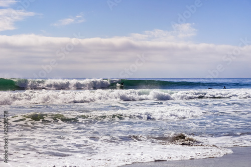 Waddell Beach and good surfing waves on a sunny day, Pacific Ocean coastline, Davenport, California