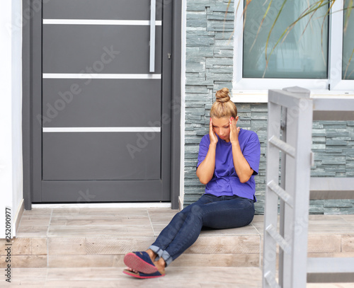 Portrait of depressed woman sitting on stairs at home.Crying woman