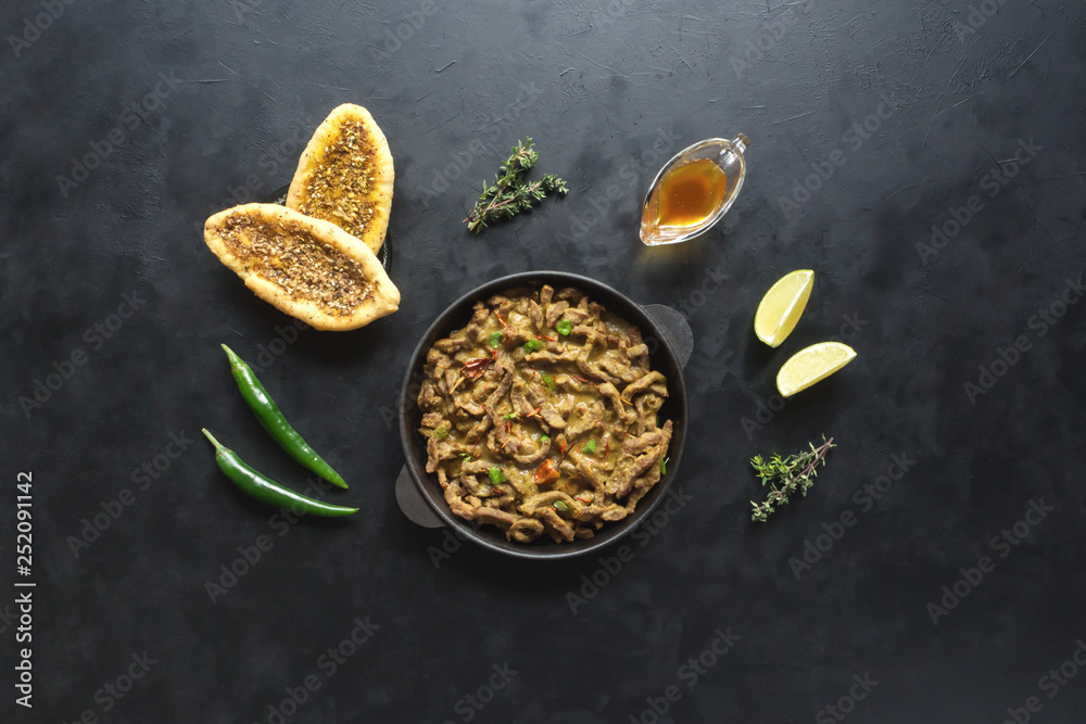 Meat thin slices cooked in a pan with curry sauce. Meat thin slices cooked in a pan with curry sauce.